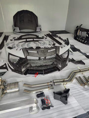 WIDE BODY KIT WITH EXHAUST CATBACK SYSTEM for LAMBORGHINI URUS 2018+  Set includes:  Front bumper Dry carbon front lip Dry carbon hood/bonnet Dry carbon front bumper eyebrows Front fenders Front fender flares Side skirts Dry carbon roof spoiler Dry carbon middle decklid spoiler Dry carbon trunk panel between tail lights Rear fender flares Rear bumper Dry carbon rear bumper side air vents Dry carbon rear diffuser Exhaust system with tips