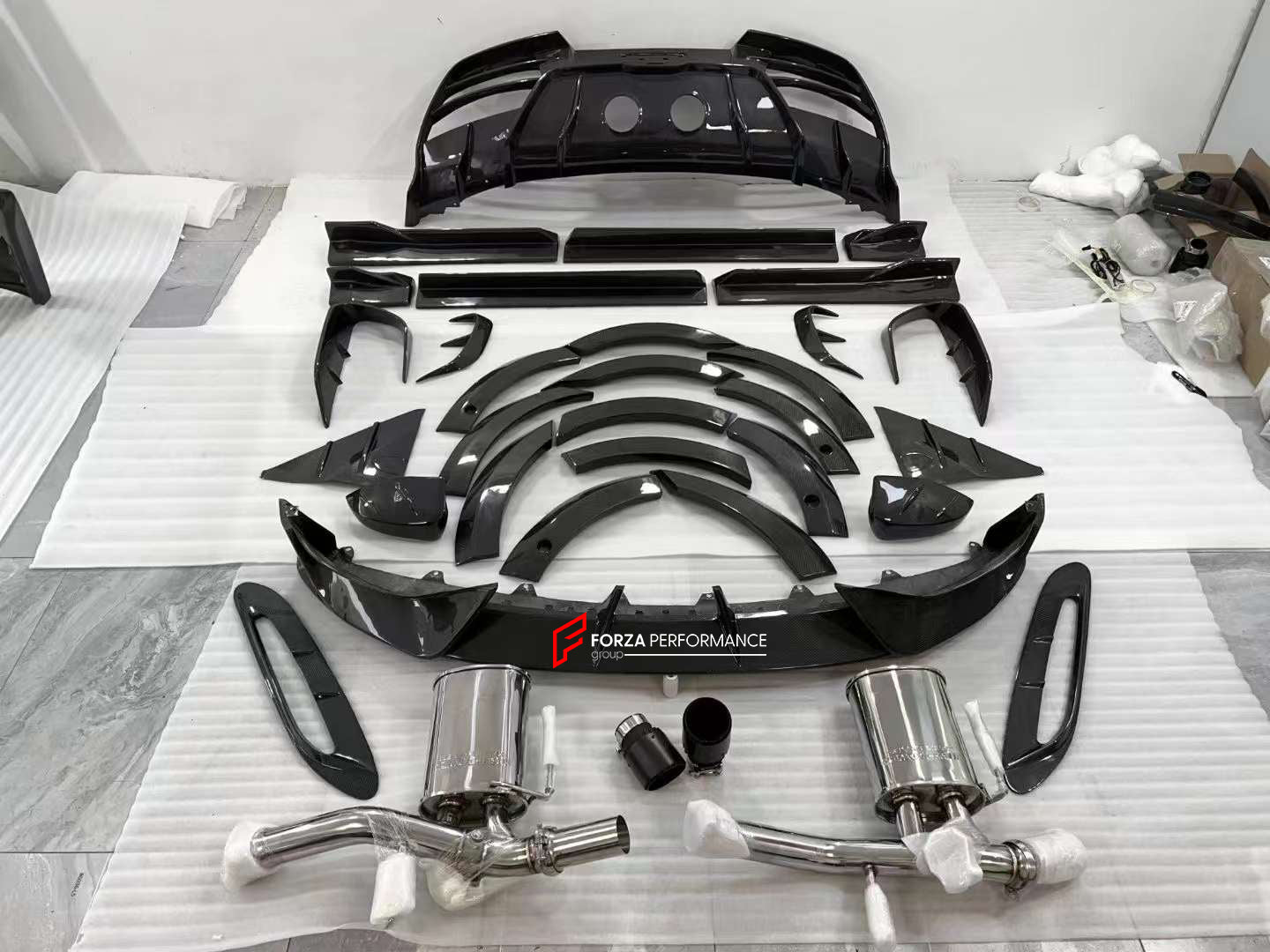 DRY CARBON BODY KIT for ASTON MARTIN DBX  Set includes:  Front Lip Side Fenders Hood Air Vents Side Air Vents Front Canards Side Skirts Rear Bumper Exhaust System Exhaust Tips