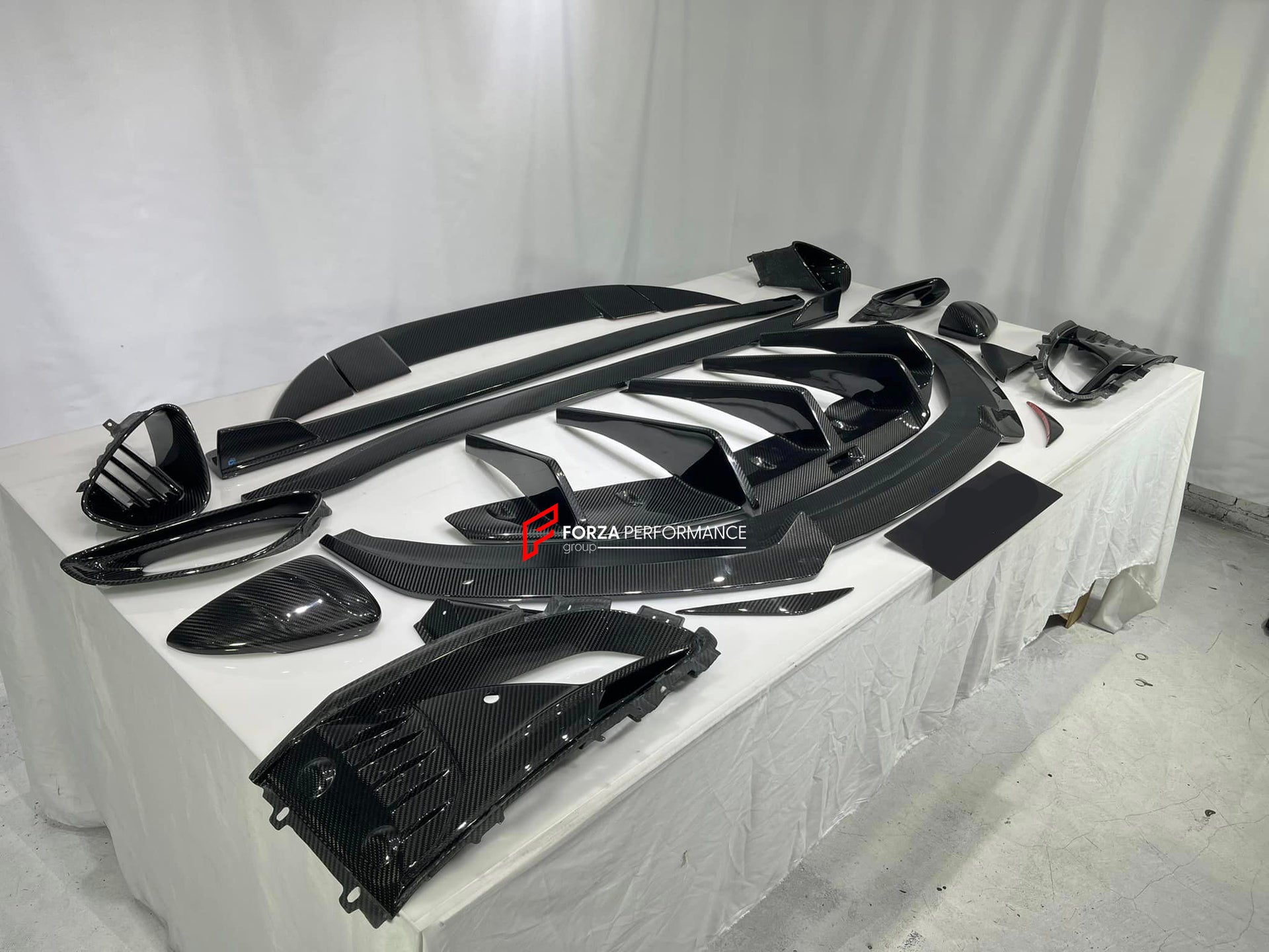 DRY CARBON BODY KIT for LOTUS EMIRA  Set includes:  Front Lip Side Skirts Rear Diffuser Rear Spoiler Front Air Vents Side Air Vents Rear Air Duct Side Mirrors