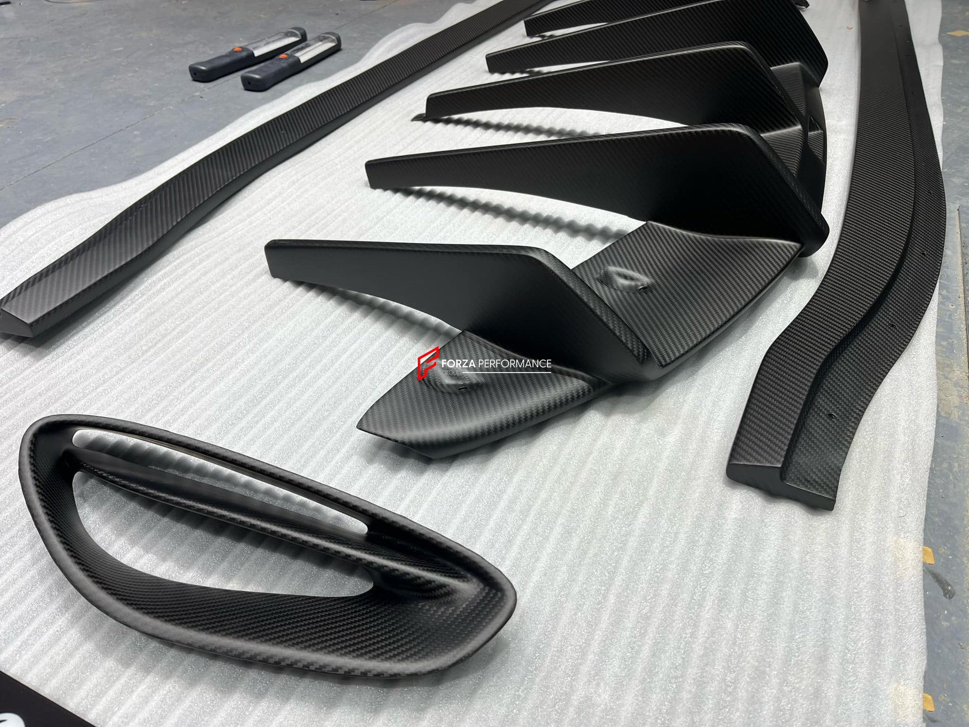 DRY CARBON BODY KIT for LOTUS EMIRA  Set includes:  Front Lip Side Skirts Rear Diffuser Rear Spoiler Front Air Vents Side Air Vents Rear Air Duct Side Mirrors