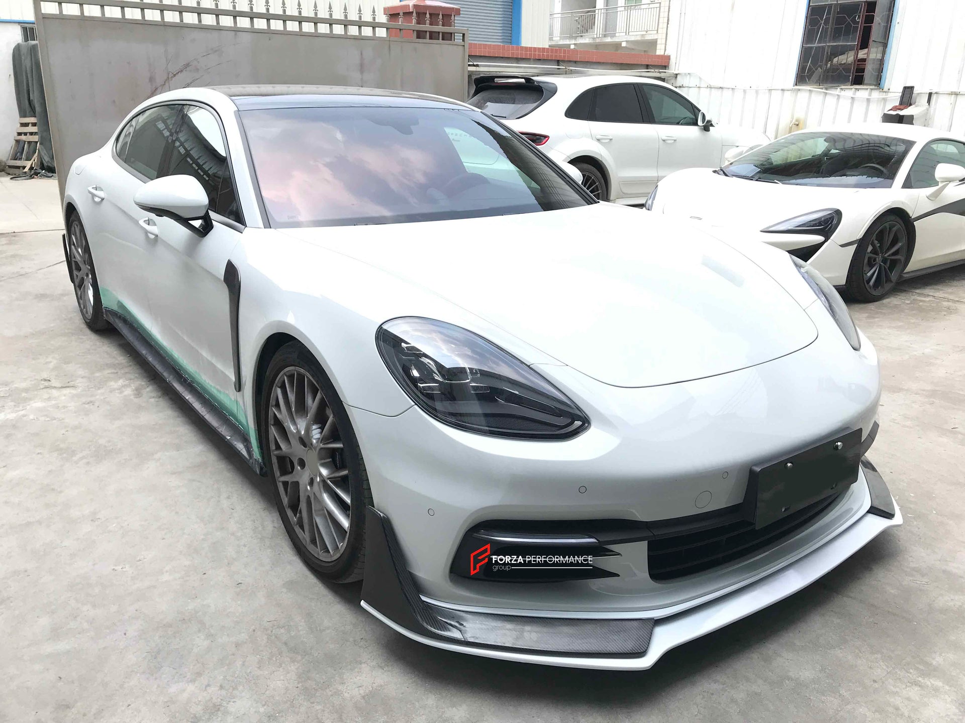 CARBON BODY KIT FOR PORSCHE PANAMERA 971 2017 - 2023

Set includes:

Front Lip
Side skirts
Side Vent
Rear Diffuser
Rear Spoiler

Material: Carbon + Plastic

NOTE: Professional installation is required. Factory LED DRL must be reused