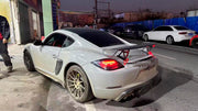 CONVERSION 718 982 GT4 BODY KIT for PORSCHE CAYMAN 987 2005 - 2013
Set includes:

Front Lip
Front Bumper Air Vent Trims
Front Bumper Fins
Front Grille
Led Light Covers / Front Fascia Attachments
License Plate
Rear Bumper Assembly (FRP)
Rear Diffuser (FRP)
Material: Plastic + FRP

NOTE: Professional installation is required.
