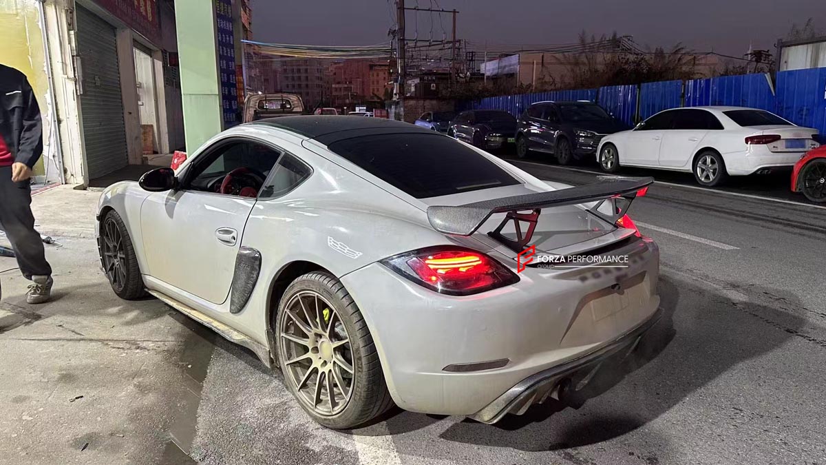 CONVERSION 718 982 GT4 BODY KIT for PORSCHE CAYMAN 987 2005 - 2013
Set includes:

Front Lip
Front Bumper Air Vent Trims
Front Bumper Fins
Front Grille
Led Light Covers / Front Fascia Attachments
License Plate
Rear Bumper Assembly (FRP)
Rear Diffuser (FRP)
Material: Plastic + FRP

NOTE: Professional installation is required.