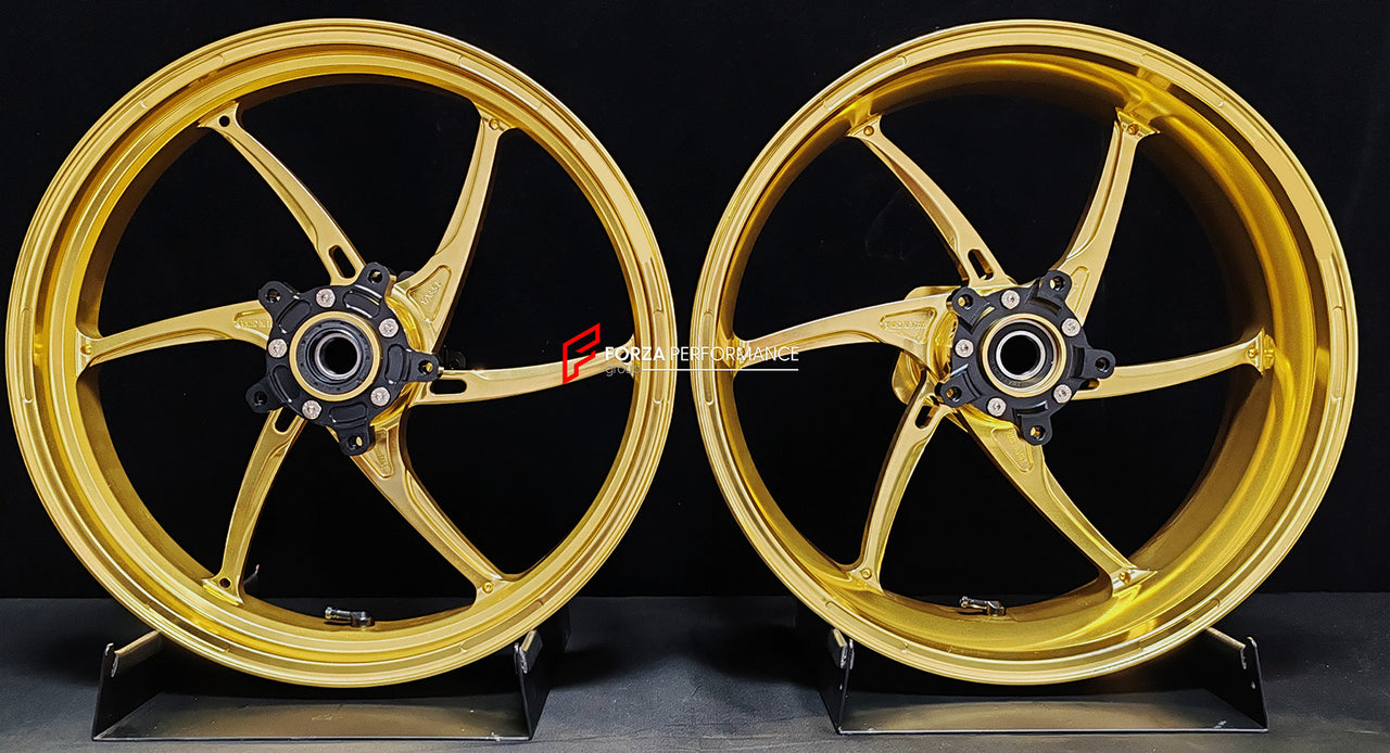 We manufacture premium quality forged motorcycle wheels rims for QJMOTOR in any design, size, color.
Wheel sizes (motorcycle spec):
Front: 3.5 x 17
Rear: 6 x 17
Weight:
Front: 3.9 kg (8.6 lbs)
Rear: 4.95 kg (10.91 lbs)
Finishing: Satin Gold
Forza Performance Group engineers and manufactures each forged motorcycle wheel individually per order. This ensures precise fitment, uncompromised strength, and unique styling. Whether for racing, touring, or daily use — our wheels are built for both performanc