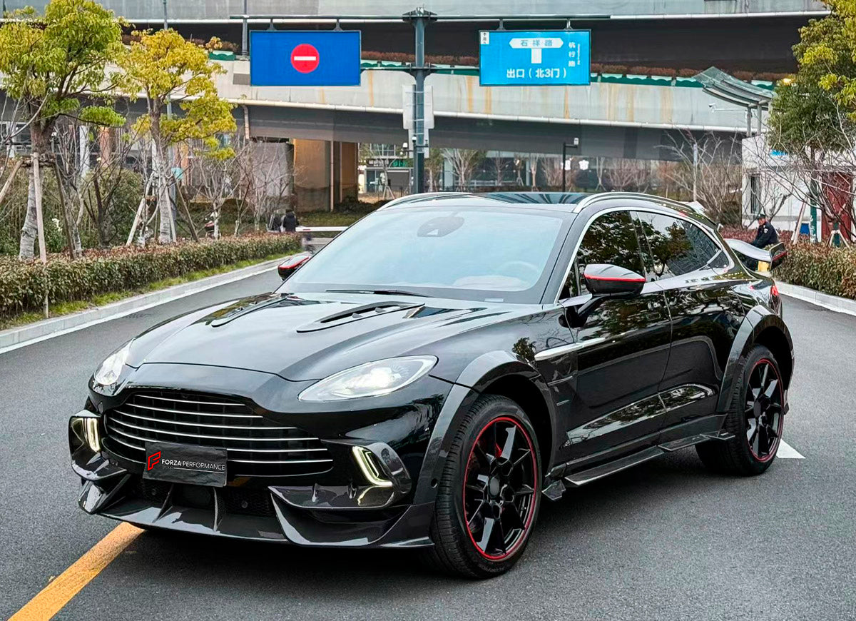 DRY CARBON BODY KIT for Aston Martin DBX AM8 2020 - 2024
Set includes:

Front Lip
Front Canards
Hood Air Vents
Side Mirrors
Side Fenders
Side Air Vents
Side Skirts
Rear Bumper
Rear Spoiler Wing
Exhaust System
Exhaust Tips
Material: Dry Carbon

NOTE: Professional installation is required.