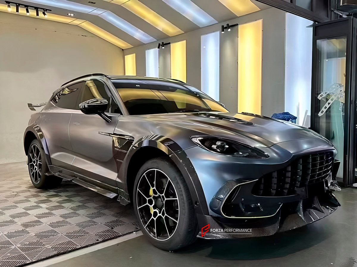DRY CARBON BODY KIT for Aston Martin DBX AM8 2020 - 2024
Set includes:

Front Lip
Front Canards
Hood Air Vents
Side Mirrors
Side Fenders
Side Air Vents
Side Skirts
Rear Bumper
Rear Spoiler Wing
Exhaust System
Exhaust Tips
Material: Dry Carbon

NOTE: Professional installation is required.
