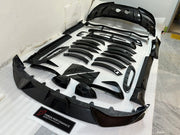 DRY CARBON BODY KIT for Aston Martin DBX AM8 2020 - 2024
Set includes:

Front Lip
Front Canards
Hood Air Vents
Side Mirrors
Side Fenders
Side Air Vents
Side Skirts
Rear Bumper
Rear Spoiler Wing
Exhaust System
Exhaust Tips
Material: Dry Carbon

NOTE: Professional installation is required.
