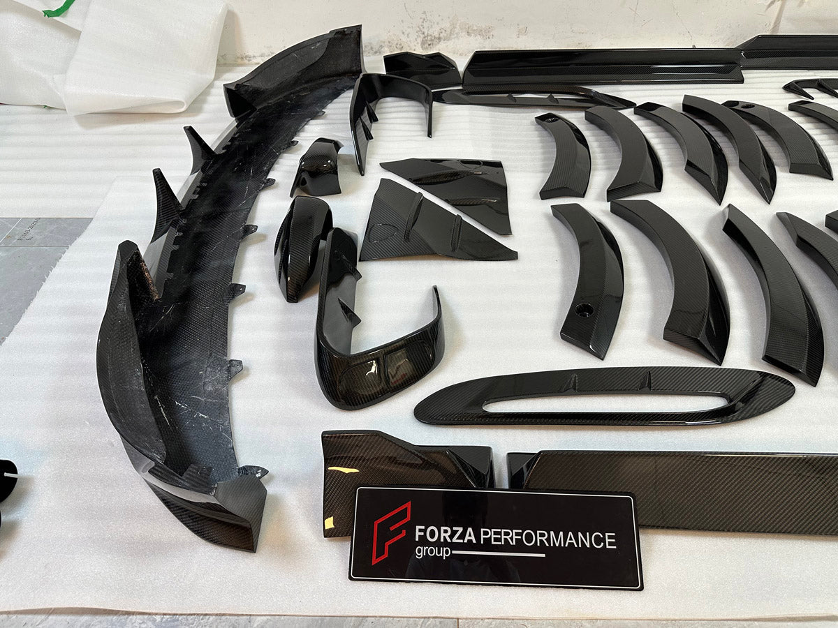 DRY CARBON BODY KIT for Aston Martin DBX AM8 2020 - 2024
Set includes:

Front Lip
Front Canards
Hood Air Vents
Side Mirrors
Side Fenders
Side Air Vents
Side Skirts
Rear Bumper
Rear Spoiler Wing
Exhaust System
Exhaust Tips
Material: Dry Carbon

NOTE: Professional installation is required.