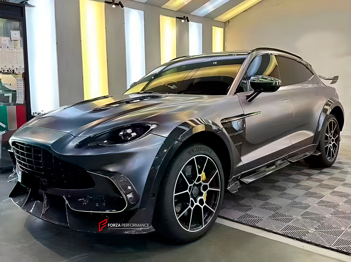 DRY CARBON BODY KIT for Aston Martin DBX AM8 2020 - 2024
Set includes:

Front Lip
Front Canards
Hood Air Vents
Side Mirrors
Side Fenders
Side Air Vents
Side Skirts
Rear Bumper
Rear Spoiler Wing
Exhaust System
Exhaust Tips
Material: Dry Carbon

NOTE: Professional installation is required.