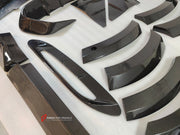 DRY CARBON BODY KIT for Aston Martin DBX AM8 2020 - 2024
Set includes:

Front Lip
Front Canards
Hood Air Vents
Side Mirrors
Side Fenders
Side Air Vents
Side Skirts
Rear Bumper
Rear Spoiler Wing
Exhaust System
Exhaust Tips
Material: Dry Carbon

NOTE: Professional installation is required.