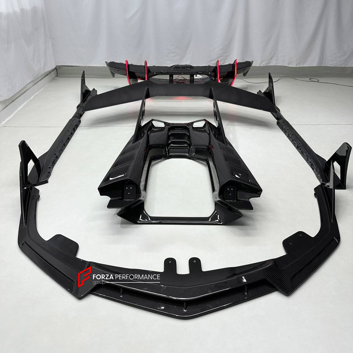 DRY CARBON BODY KIT for LAMBORGHINI REVUELTO 2023+ FORZA PERFORMANCE custom fit DK Style

Set includes:
Front Lip
Side Skirts
Rear Spoiler Wing
Engine Cover
Rear Diffuser

Material: Dry Carbon

NOTE: Professional installation is required.