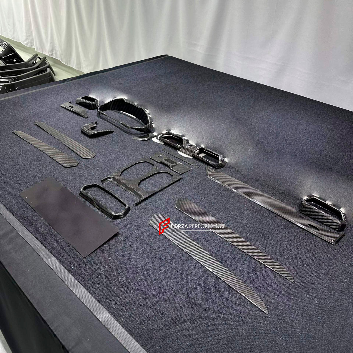 Dry Carbon Interior Kit for Lamborghini Urus 2018+
Set includes:

Dashboard Panel Cover
Meter Base Panel Cover
Central Control Panel Trim
Center Console Air Outlet Cover Trim
Material: Dry Carbon

NOTE: Professional installation is required.