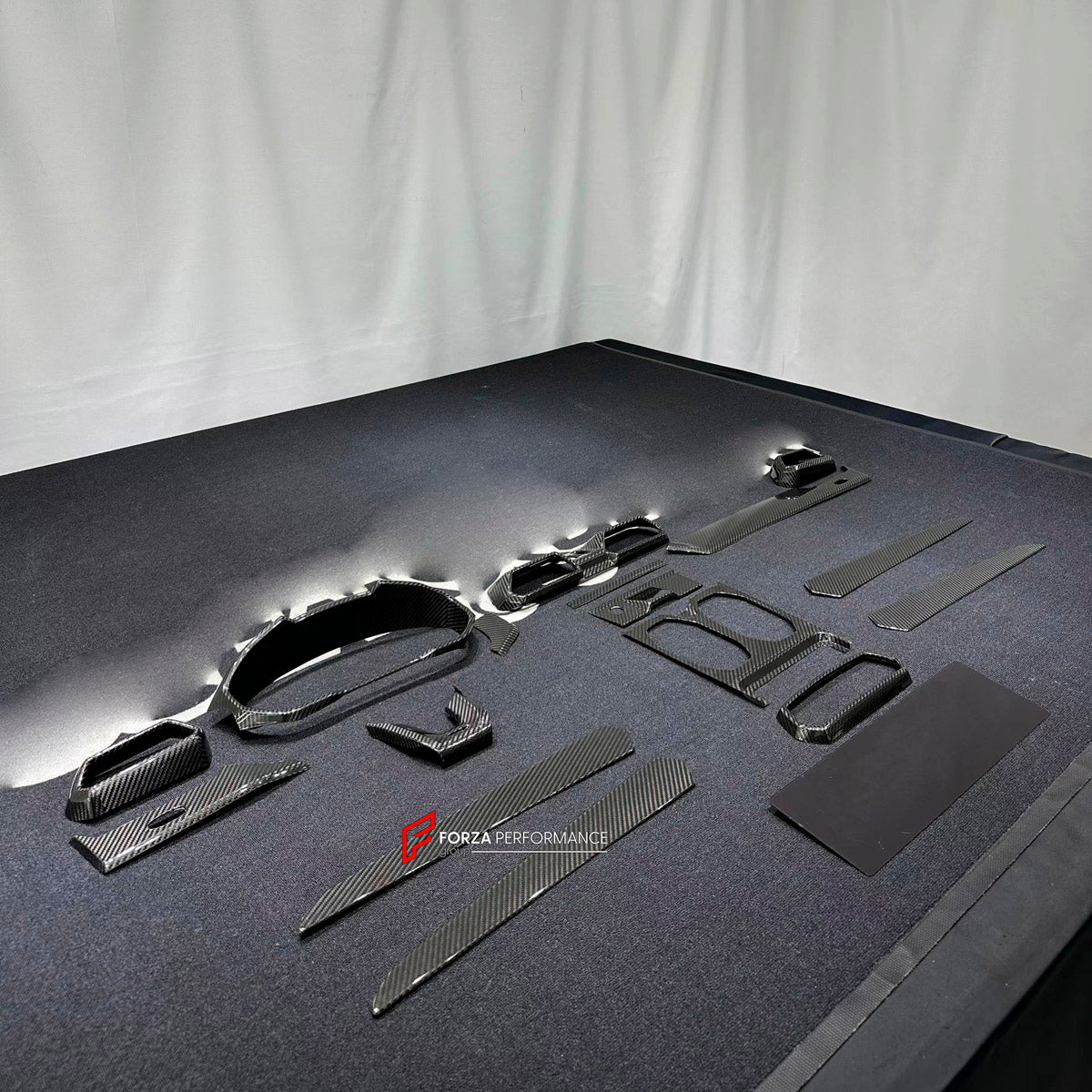 Dry Carbon Interior Kit for Lamborghini Urus 2018+
Set includes:

Dashboard Panel Cover
Meter Base Panel Cover
Central Control Panel Trim
Center Console Air Outlet Cover Trim
Material: Dry Carbon

NOTE: Professional installation is required.