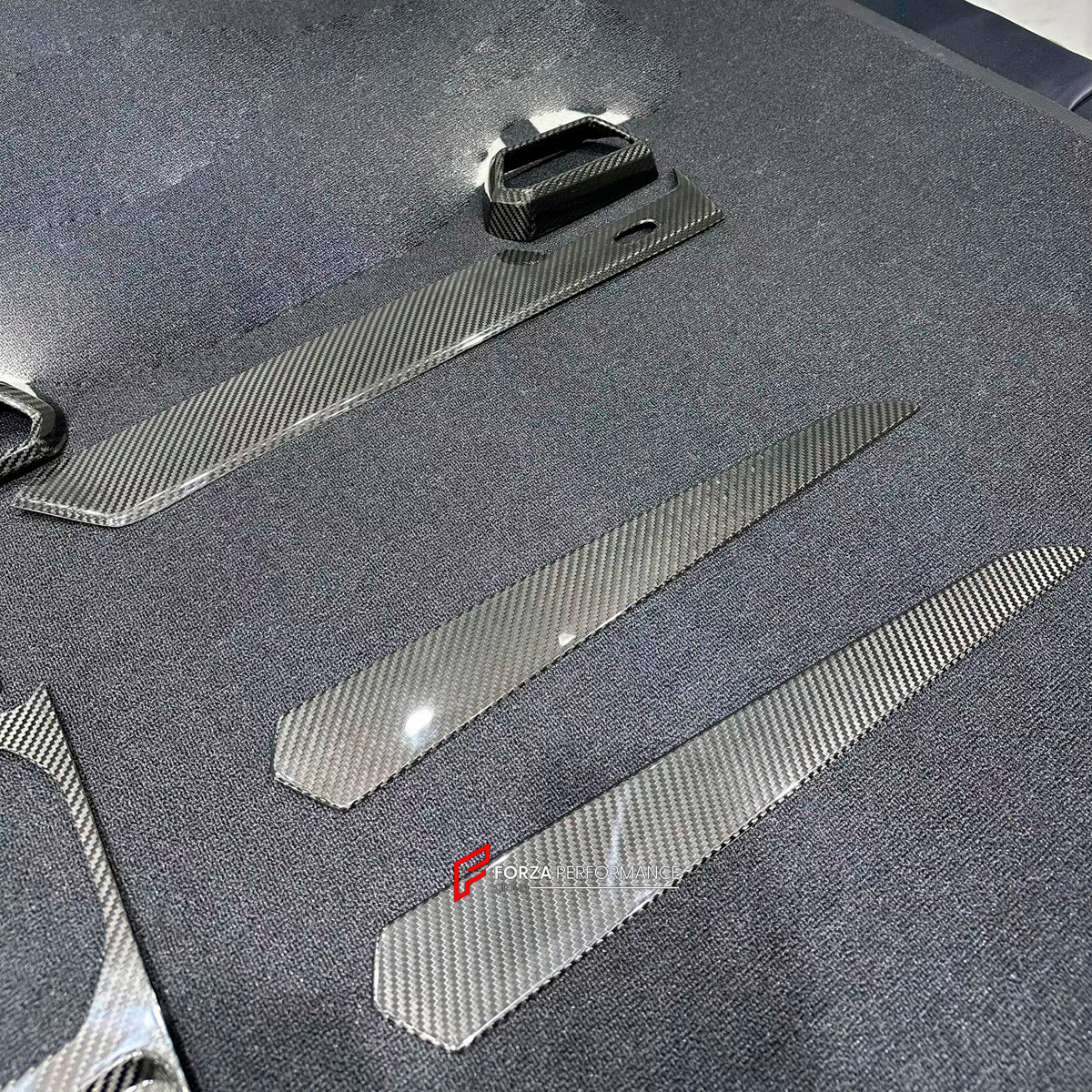 Dry Carbon Interior Kit for Lamborghini Urus 2018+
Set includes:

Dashboard Panel Cover
Meter Base Panel Cover
Central Control Panel Trim
Center Console Air Outlet Cover Trim
Material: Dry Carbon

NOTE: Professional installation is required.