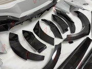 DRY CARBON WIDE BODY KIT for FERRARI PUROSANGUE 2023+ FORZA PERFORMANCE Mansory Keyvany
Set includes:

Front Lip
Front Bumper Assembly
Hood Bonnet
Front Fenders
Fender Flares
Side Skirts
Rear Fenders
Roof Spoiler
Ducktail Spoiler
Rear Diffuser
Rear Bumper Assembly
Material: Dry Carbon

NOTE: Professional installation is required.