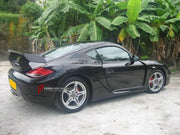 WIDE BODY KIT for Porsche Cayman 987 2009 - 2011
Set includes:

Front Bumper
Front Fender Flares
Side Skirts
Rear Fender Flares
Rear Bumper
Rear Spoiler Wing
Material: Plastic

NOTE: Professional installation is required.