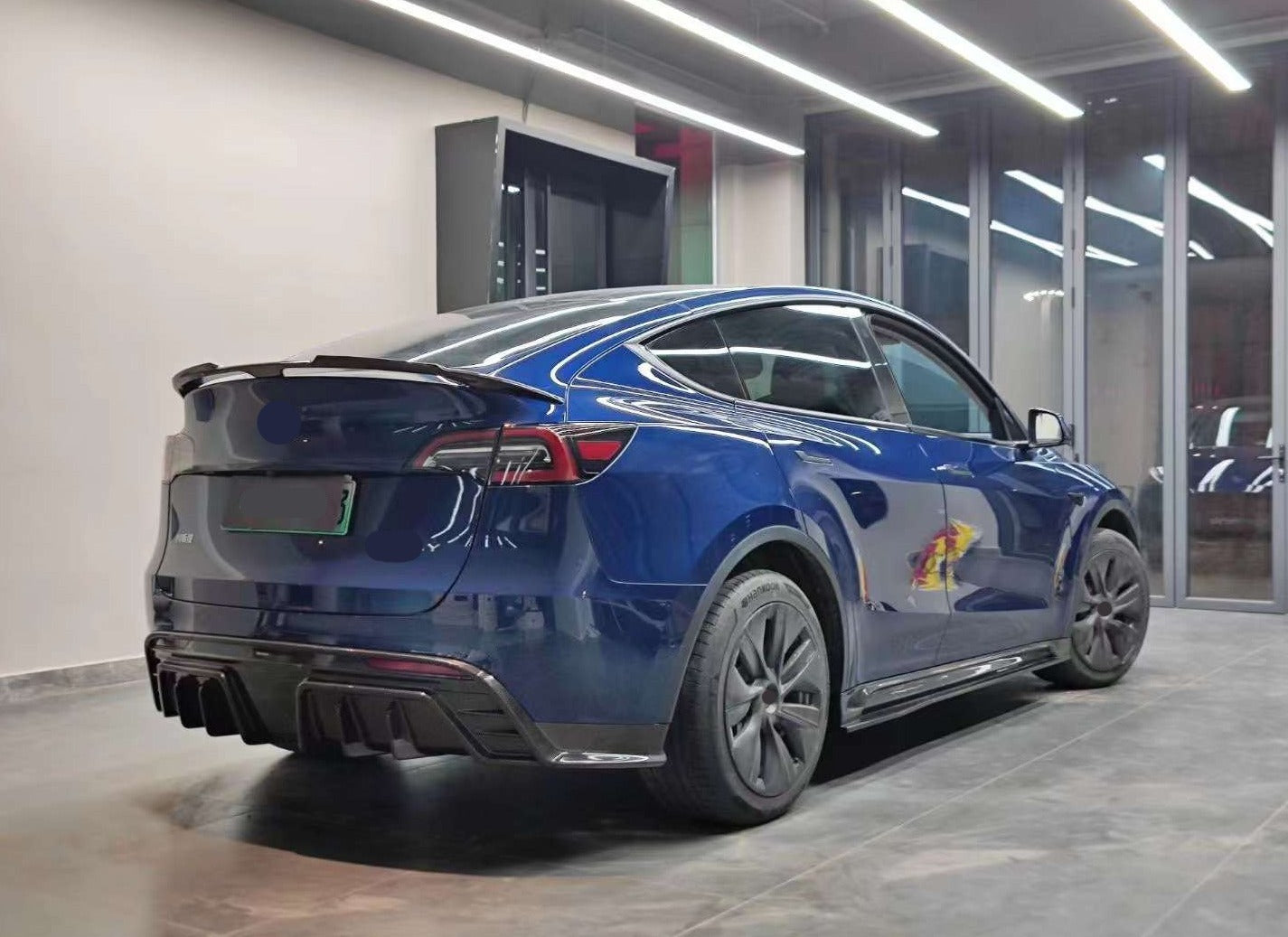 Forza Carbon Body Kit Design for Tesla Model Y  Set includes:  Front lip Side skirts  Rear diffuser Rear spoiler