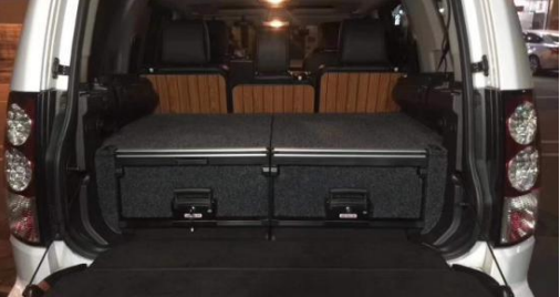 Slide Kitchen Drawer Systems For Land Rover Discovery 4 by Forza Performance  Simplify the storage and organization of equipment and valuables. These lockable drawers with integrated deck and faceplates were designed specifically for the Land Rover Discovery 4. Hide the contents from prying eyes, while creating a more convenient and easily accessible storage space in your car. Designed solidly for tough for both on and off-road travel.