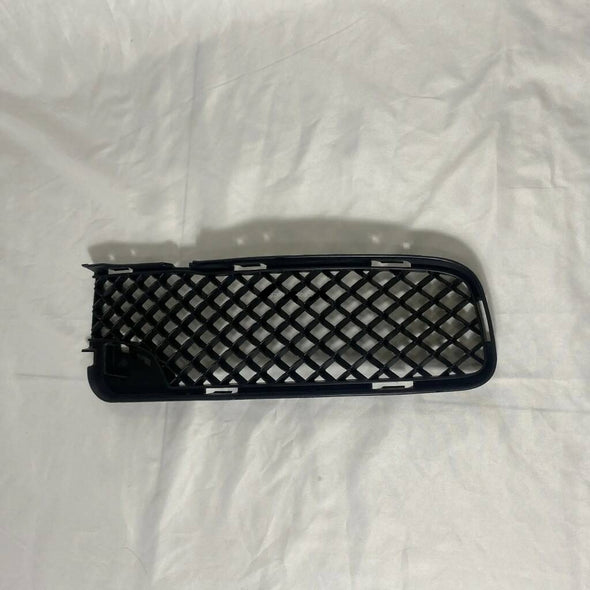 The Front Bumper Lower Grille for the 1st generation Rolls-Royce Ghost (2010-2016) is a stylish and functional accessory for the luxury vehicle. It is located at the bottom of the front bumper and serves as a decorative element while also providing air intake for the engine. The grille is made of high-quality materials and is designed to match the vehicle's sleek, elegant appearance. It is a must-have for those who want to enhance the look of their Ghost while maintaining its performance.
